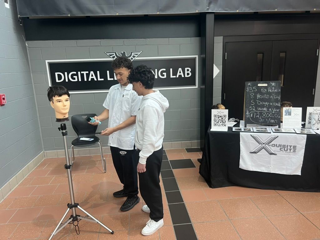 Lakota East Career Fair - Student Demo 1 Student demonstrating barbering techniques on a mannequin head at Lakota East Digital Learning Lab booth.