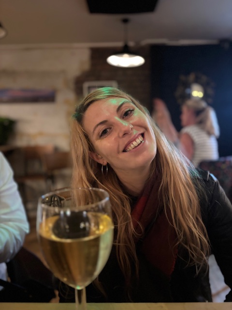 A guest enjoys a glass of locally curated wine in our cozy Brighton taproom