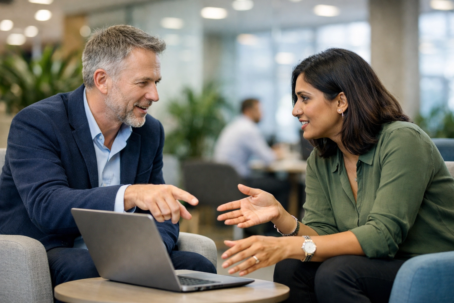 UK business partners discussing SEO strategy and key performance indicators in a modern office.