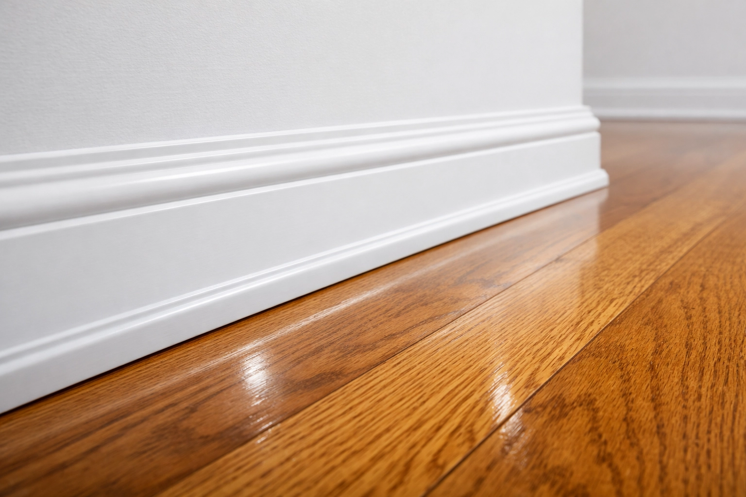 Pristine white baseboards and polished hardwood floors following professional apartment cleaning Boston.