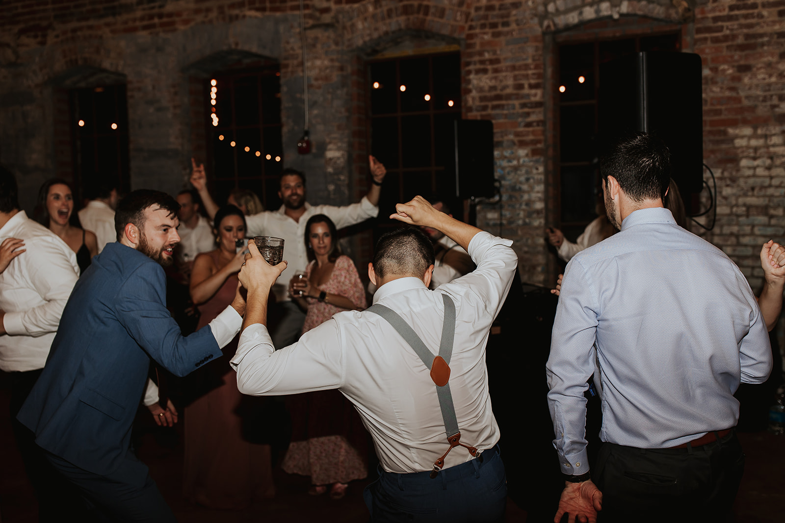 Guests Dancing at Rustic Brick Venue