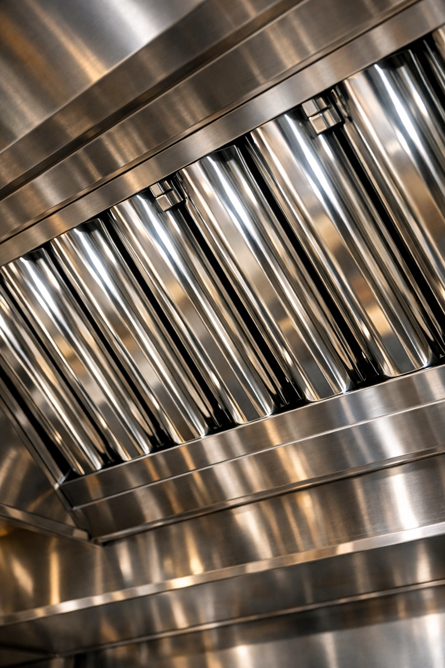 NFPA 96 compliant stainless steel baffle filters in a commercial kitchen exhaust hood.