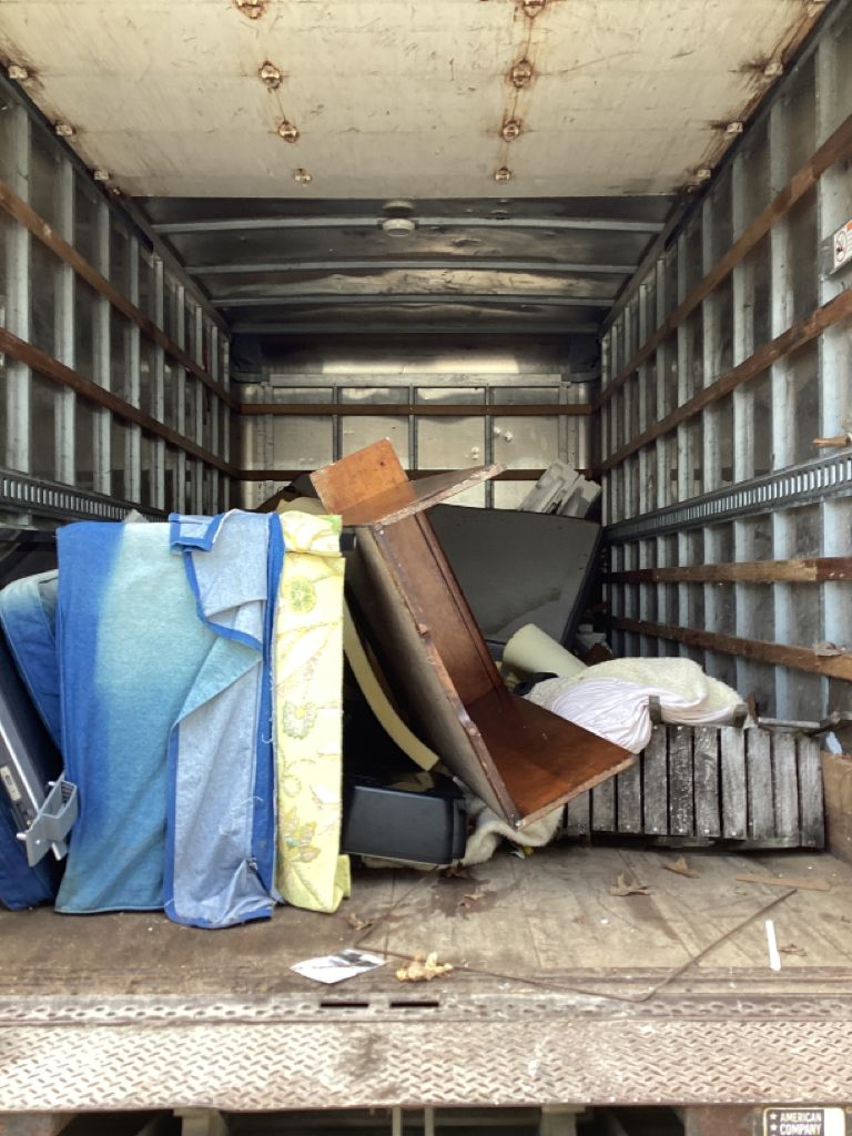 Junk Titan truck fully loaded after a household cleanout in Northwestern & Central Michigan.