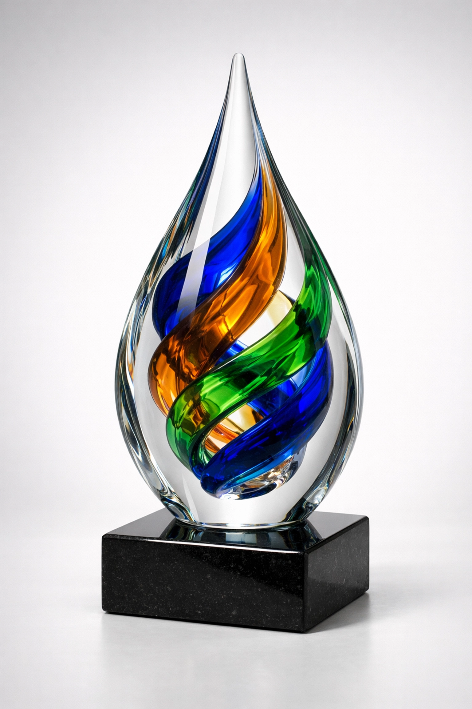 Vibrant hand-blown art glass award with colorful swirls on a polished black stone base.