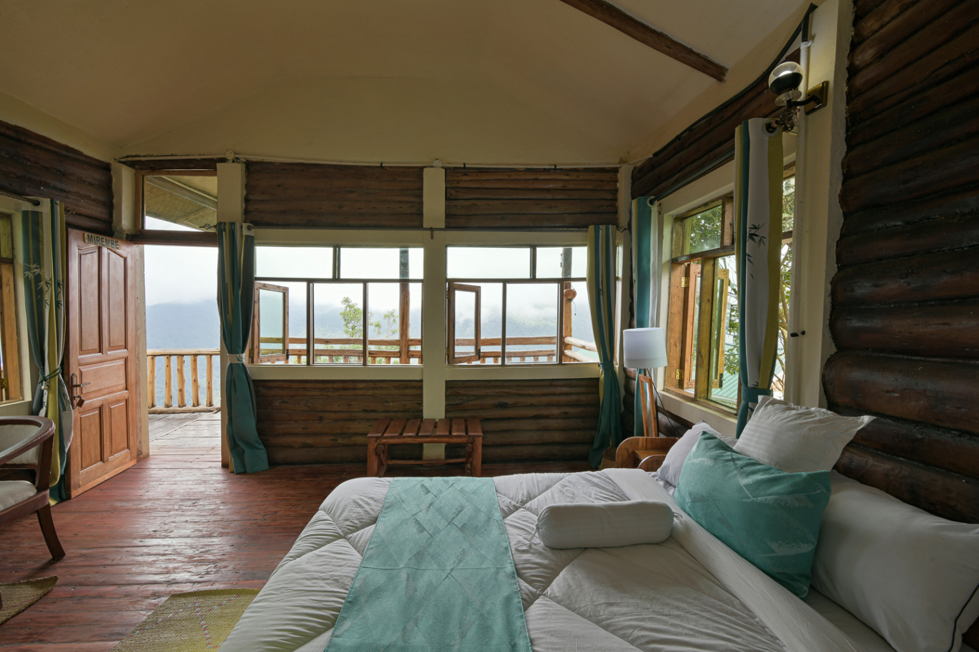 Elegant eco-luxury guest room at Orugano Bwindi Lodge with panoramic Virunga Mountain views