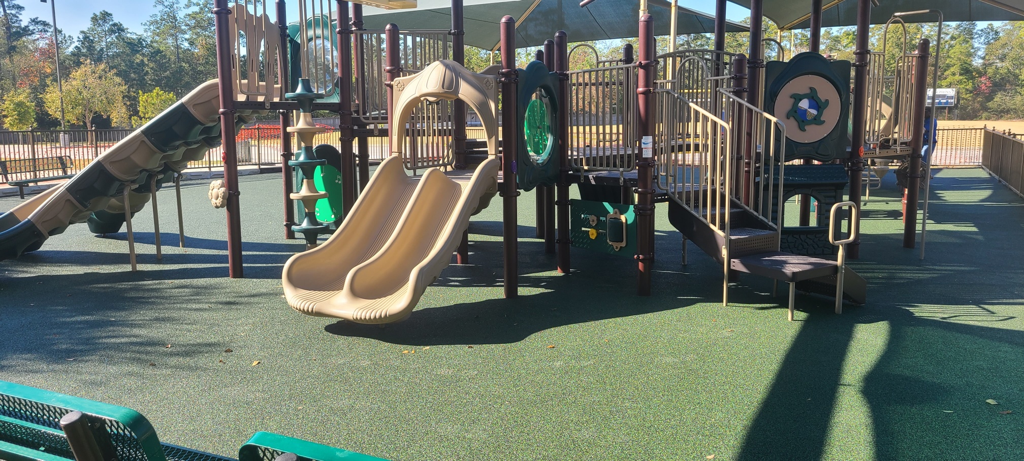 ADA-friendly playground with poured-in-place surfacing and shade canopies—built for safe, inclusive family time