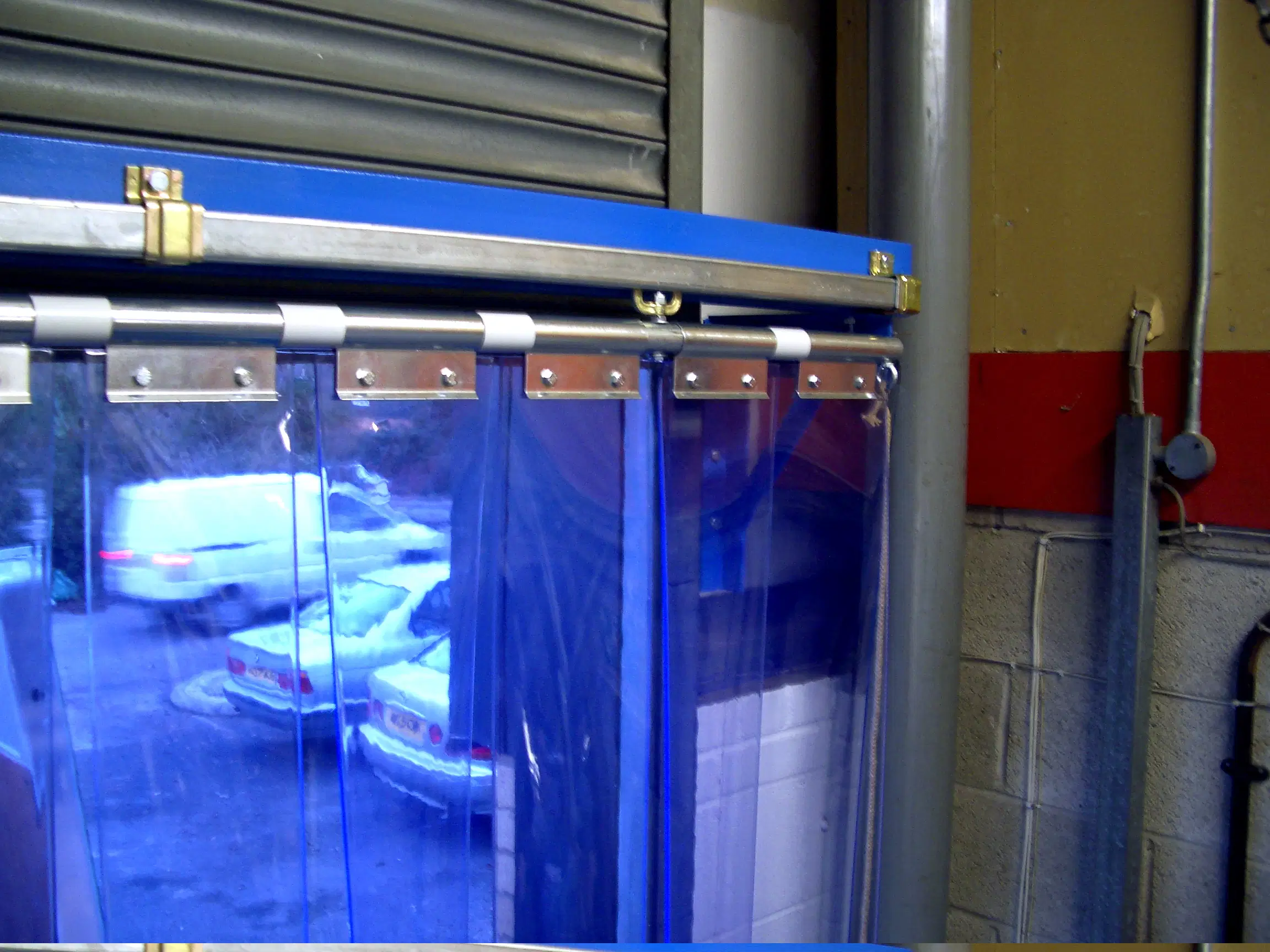Industrial separation using blue-tinted PVC strip curtains