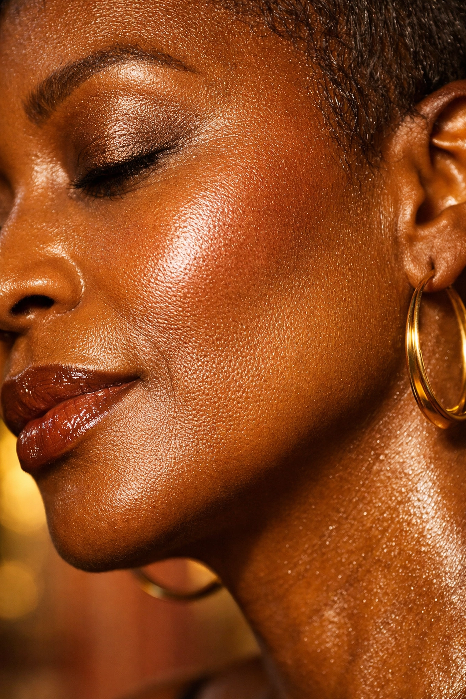 Close-up of a mature Black woman with a radiant, dewy glow and deeply hydrated skin texture.