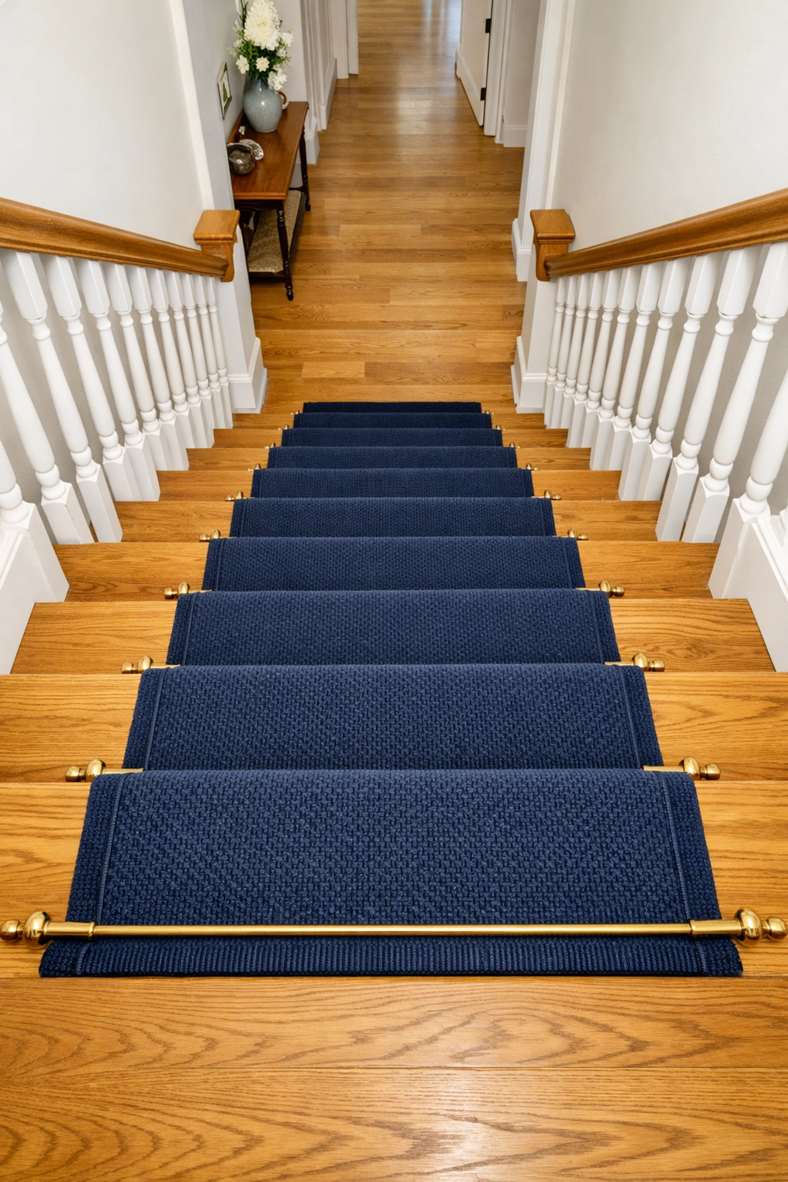 Secure low-pile carpet runner on wooden stairs providing non-slip traction and clear step definition.