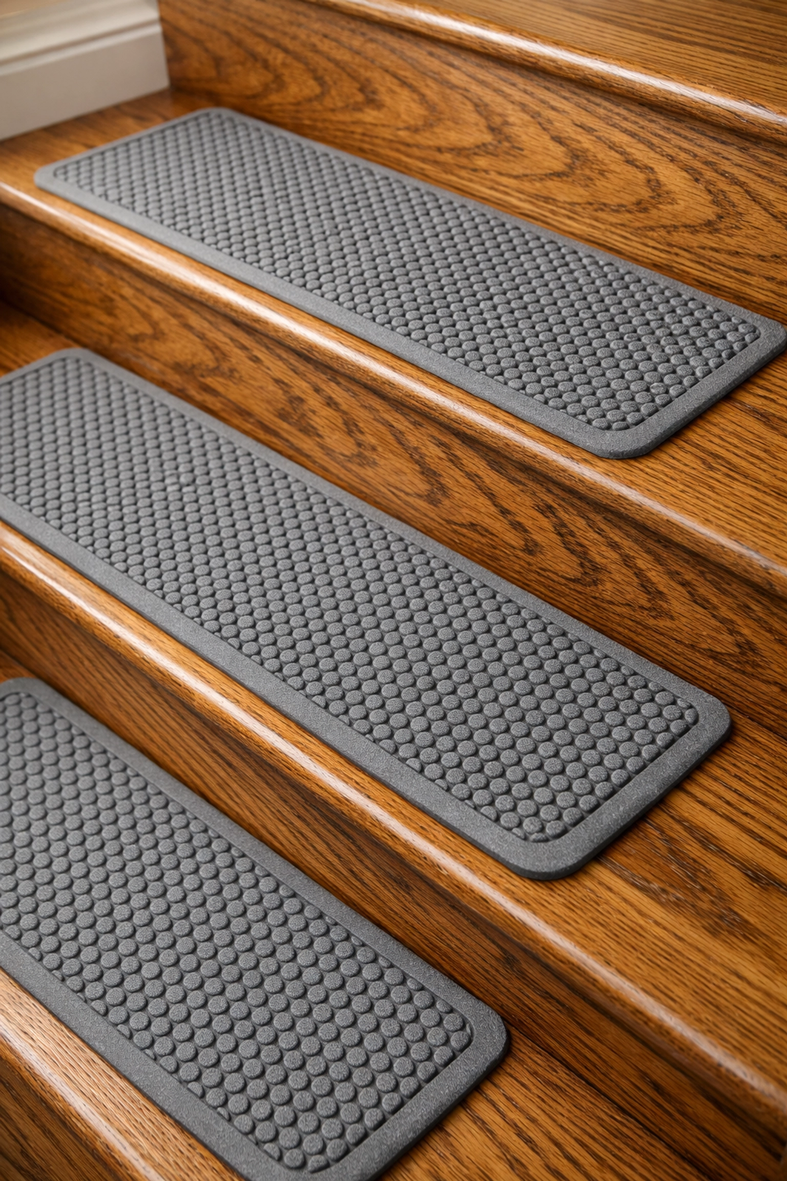 Non-slip rubber stair treads installed on wooden steps for fall prevention and traction