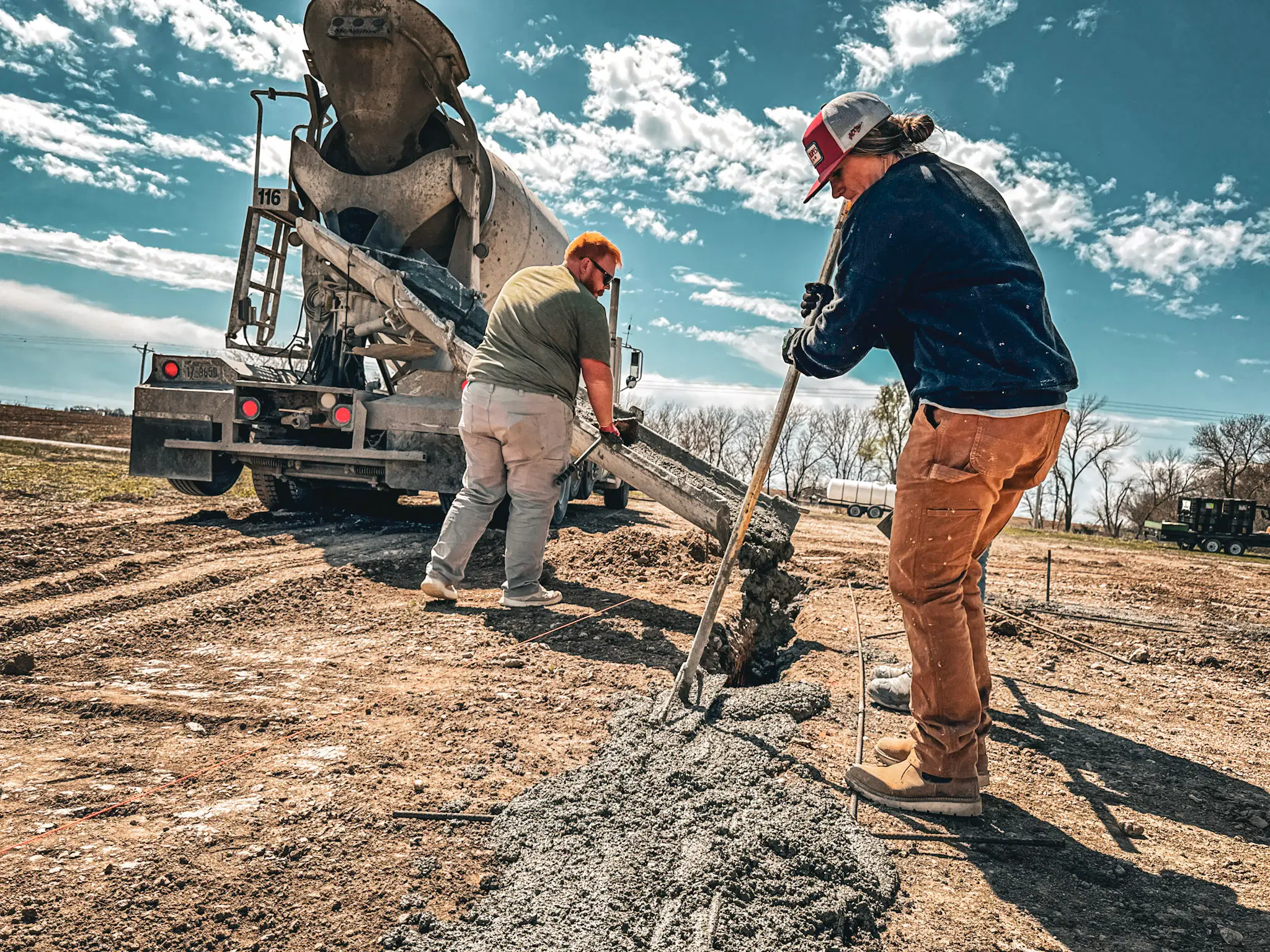 A concrete pump truck delivers fresh concrete for a new residential driveway