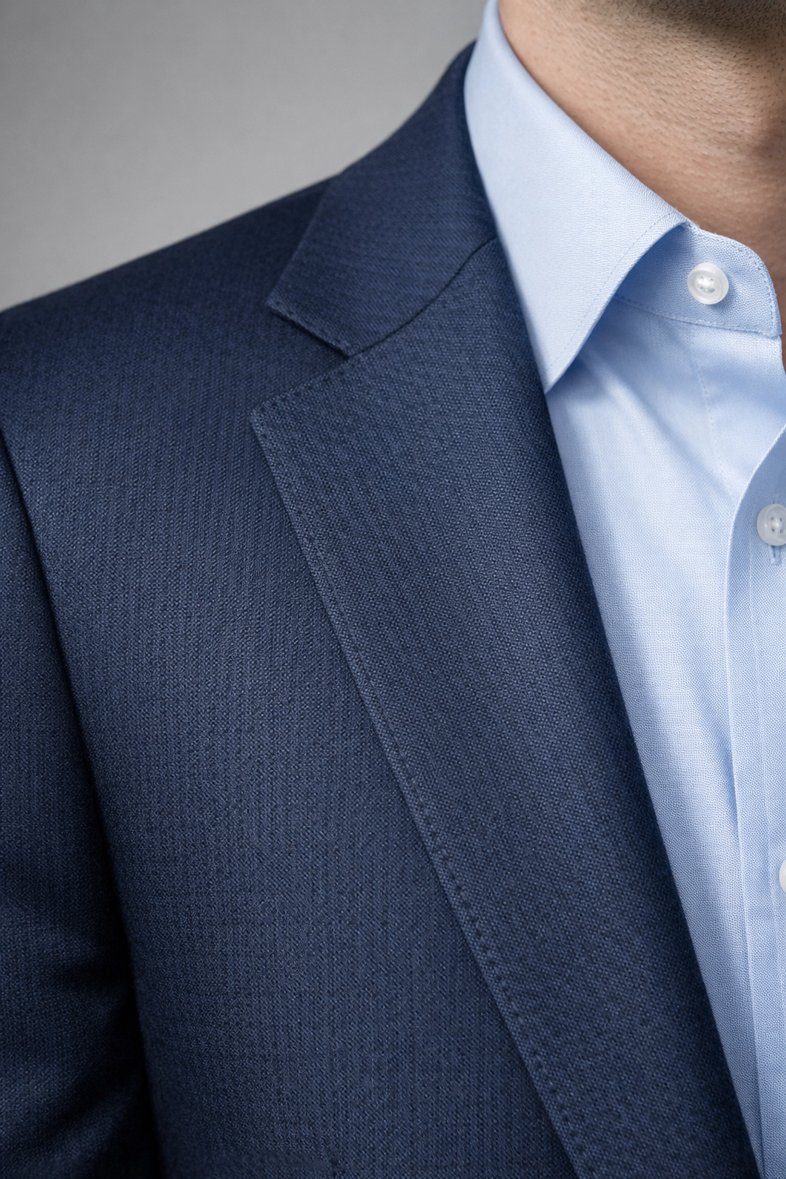 Close-up of professional corporate headshot attire featuring a well-fitted navy blazer.