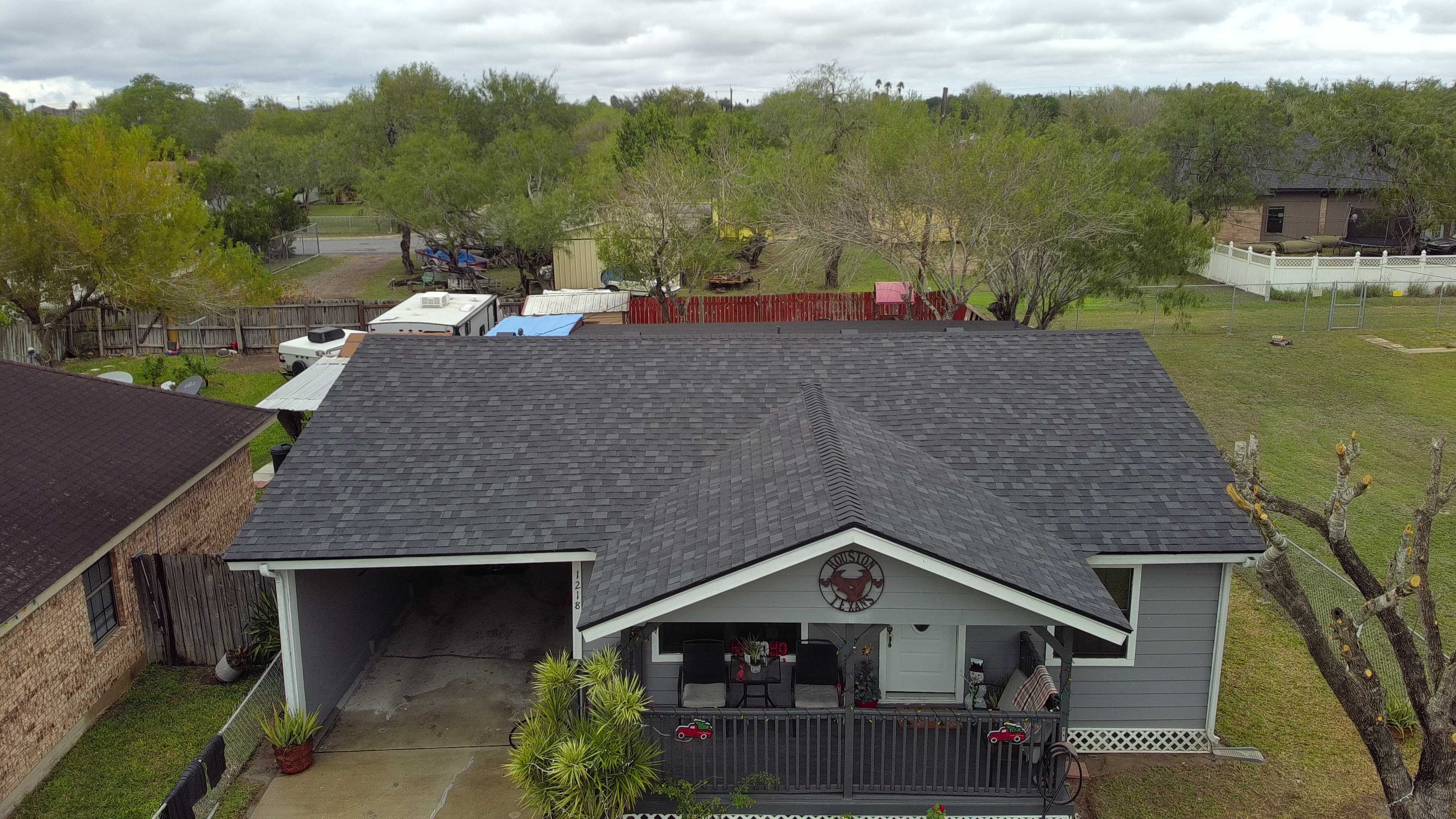 Single-story home with new asphalt shingle roof Aerial view of a single-story residential home featuring a newly installed, high-quality asphalt shingle roof.