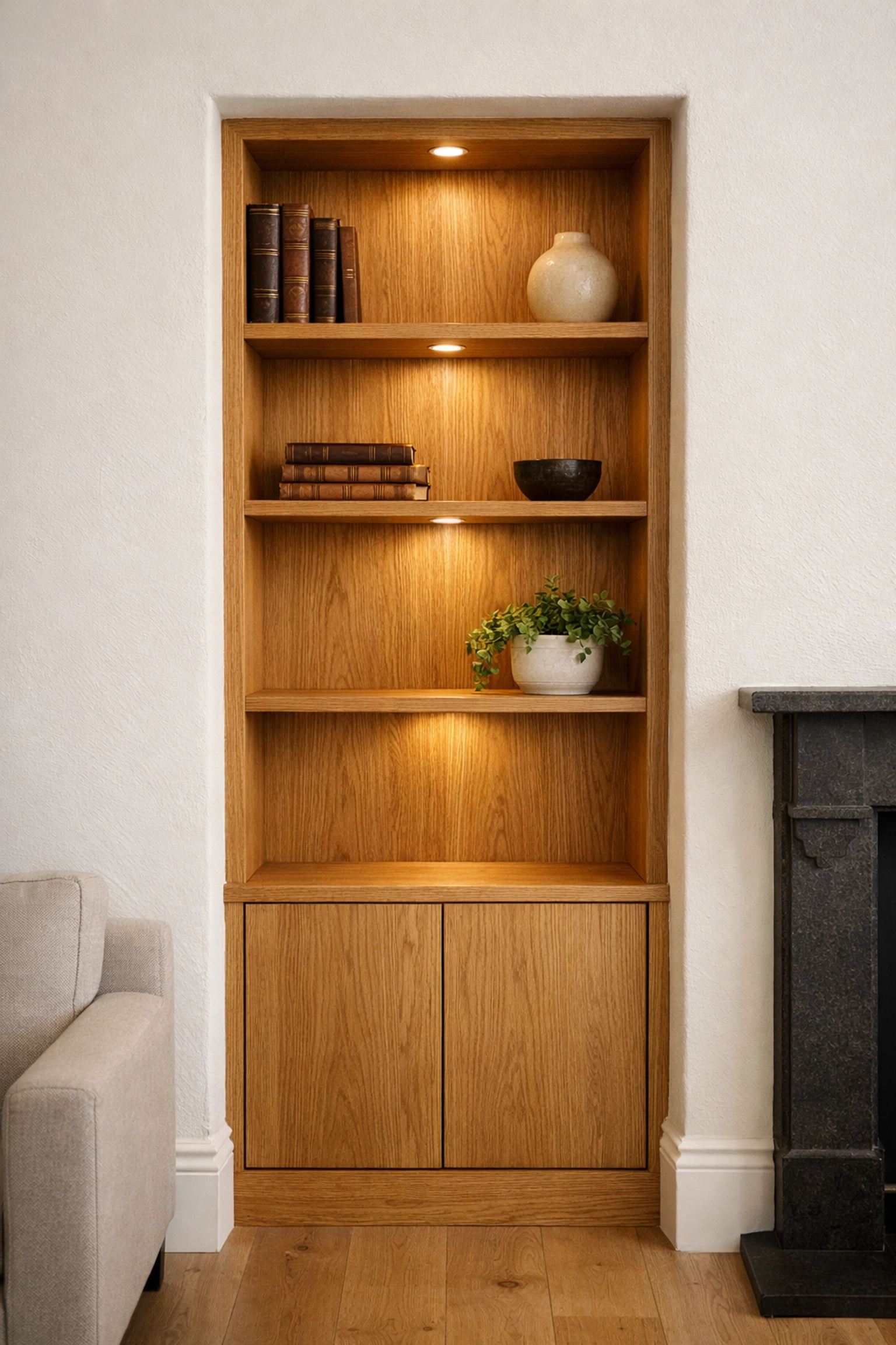 Custom oak alcove shelves designed and installed by a Bracknell carpenter in a living room.
