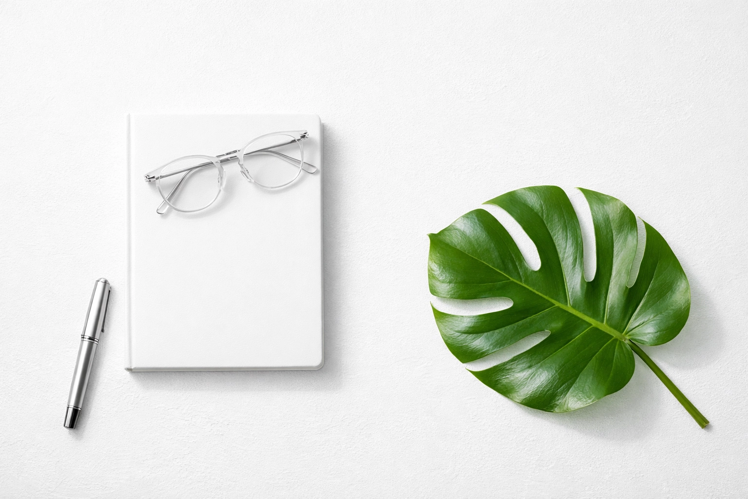Minimalist desk with a journal and pen representing a strategic small business content plan.