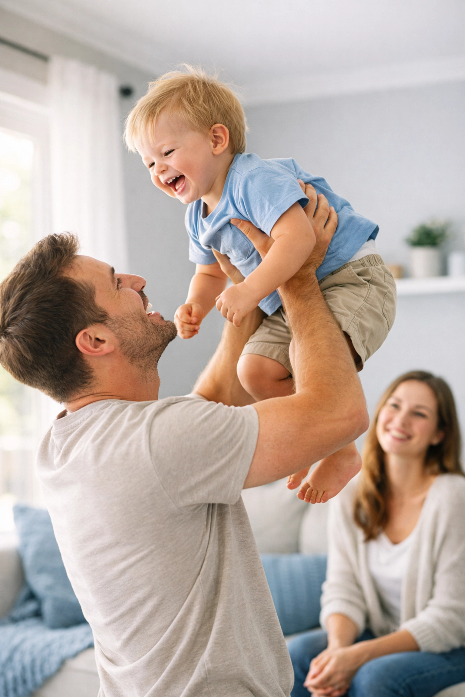 Happy father lifting toddler in a sunny home, symbolizing life insurance protection and financial security for families.