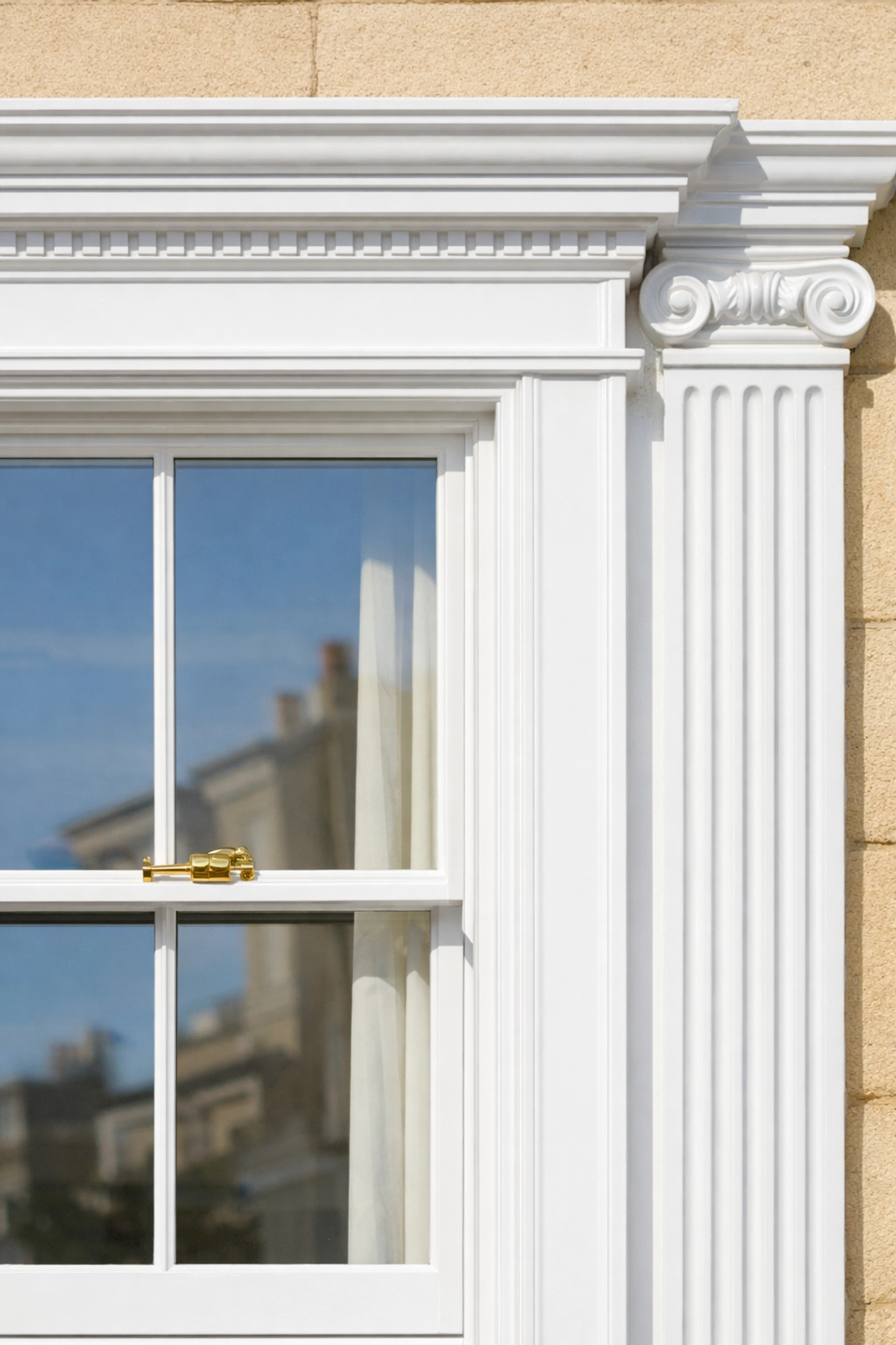 Exterior painting on a Cheltenham townhouse with white gloss sash and Cotswold stone.