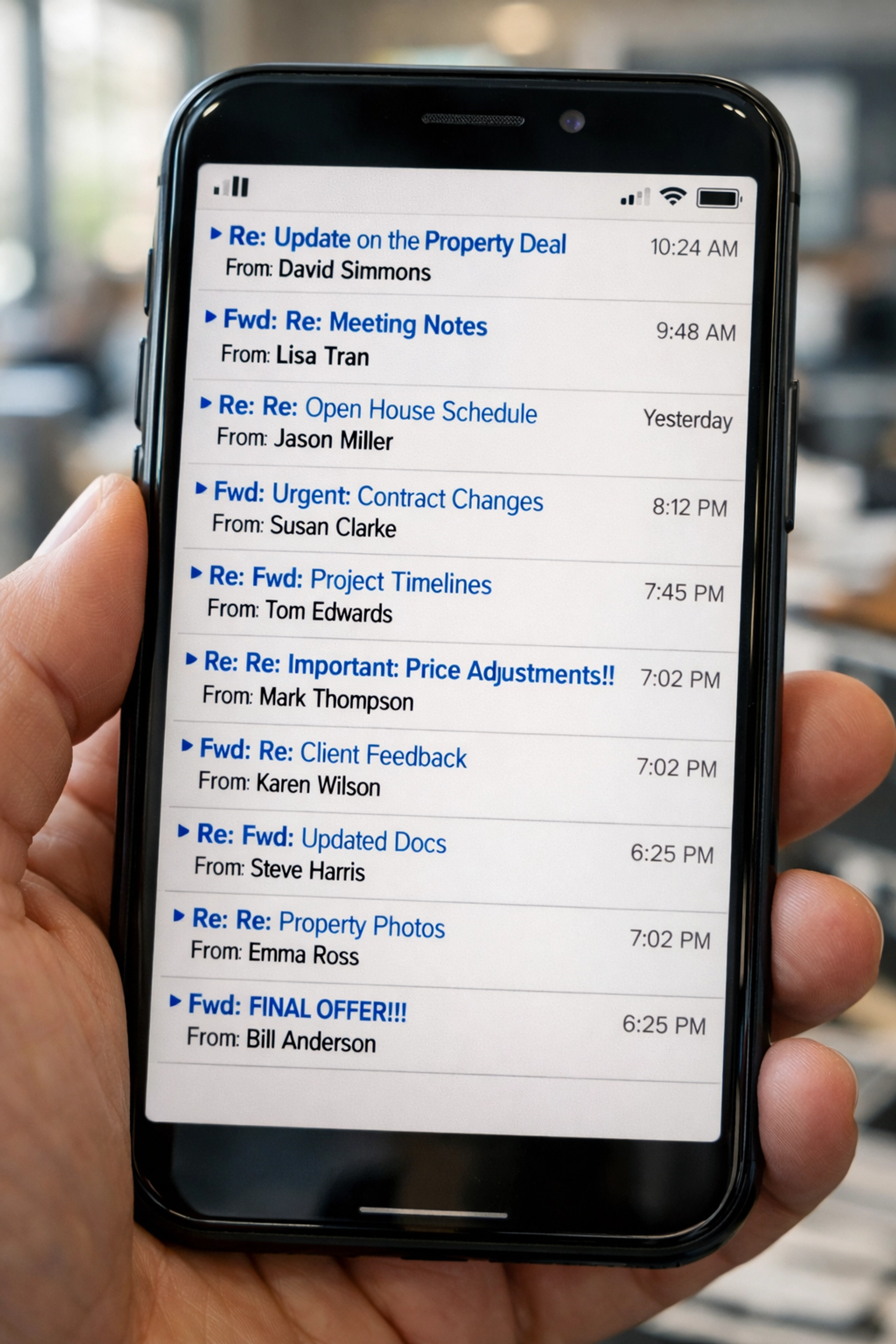 Smartphone displaying complex email thread for real estate wire transfer instructions