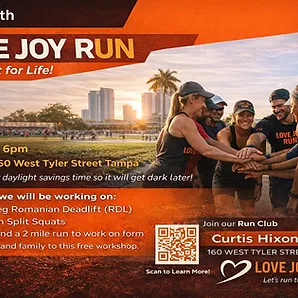 Group of runners in LOVE JOY RUN gear gather together at sunset with a city skyline behind them