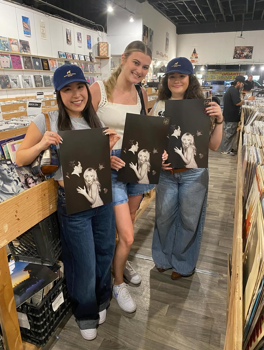 Three customers at Nivessa browse the vinyl aisles