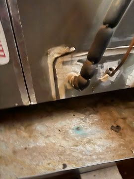 Close-up of an HVAC unit’s condensate drain line inspection