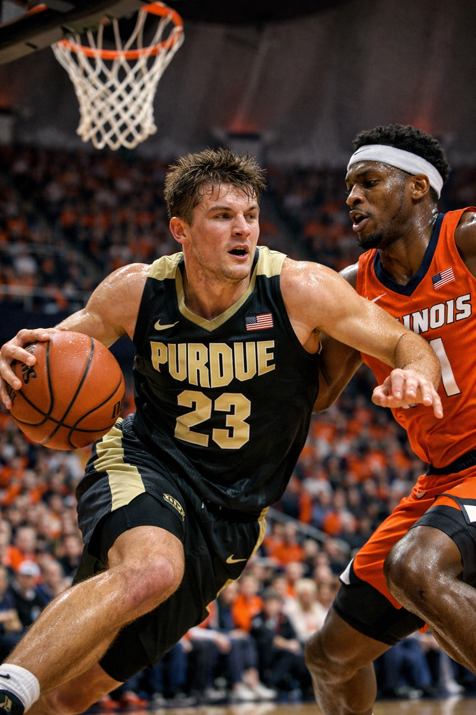 A Purdue Boilermakers guard drives to the hoop against an Illinois defender during a Big Ten basketball game.