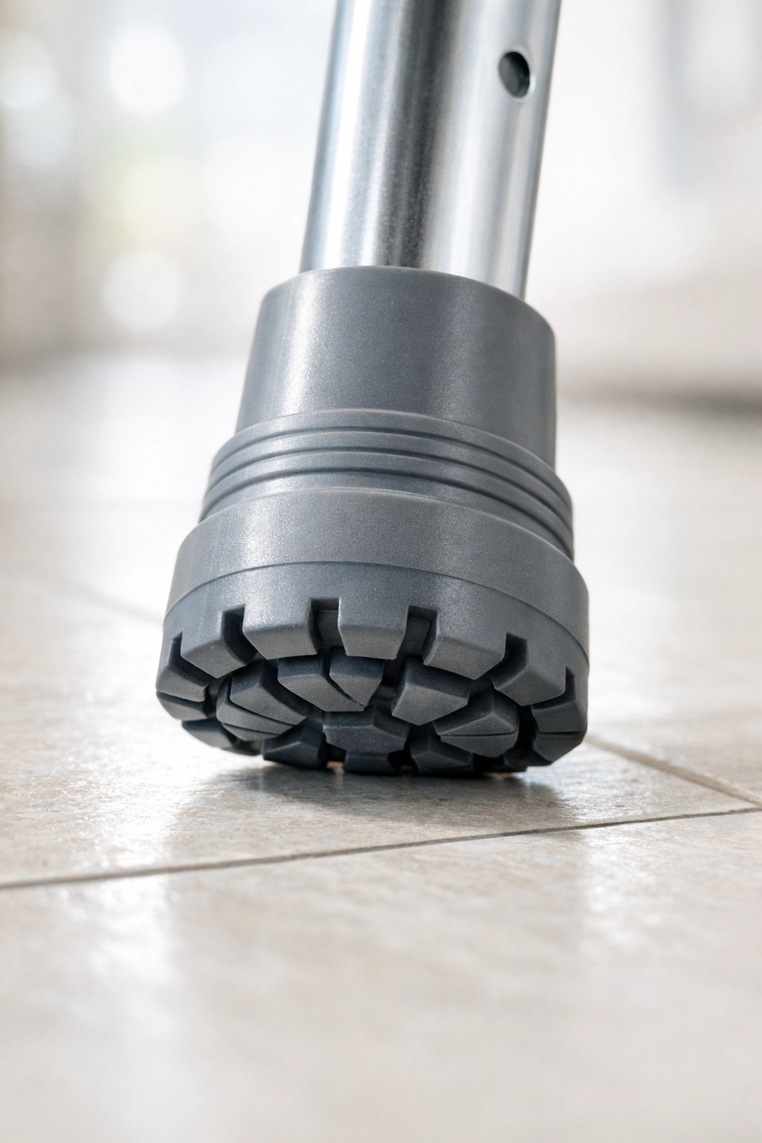 New slip-resistant rubber tip on a walker leg for improved grip and fall prevention.