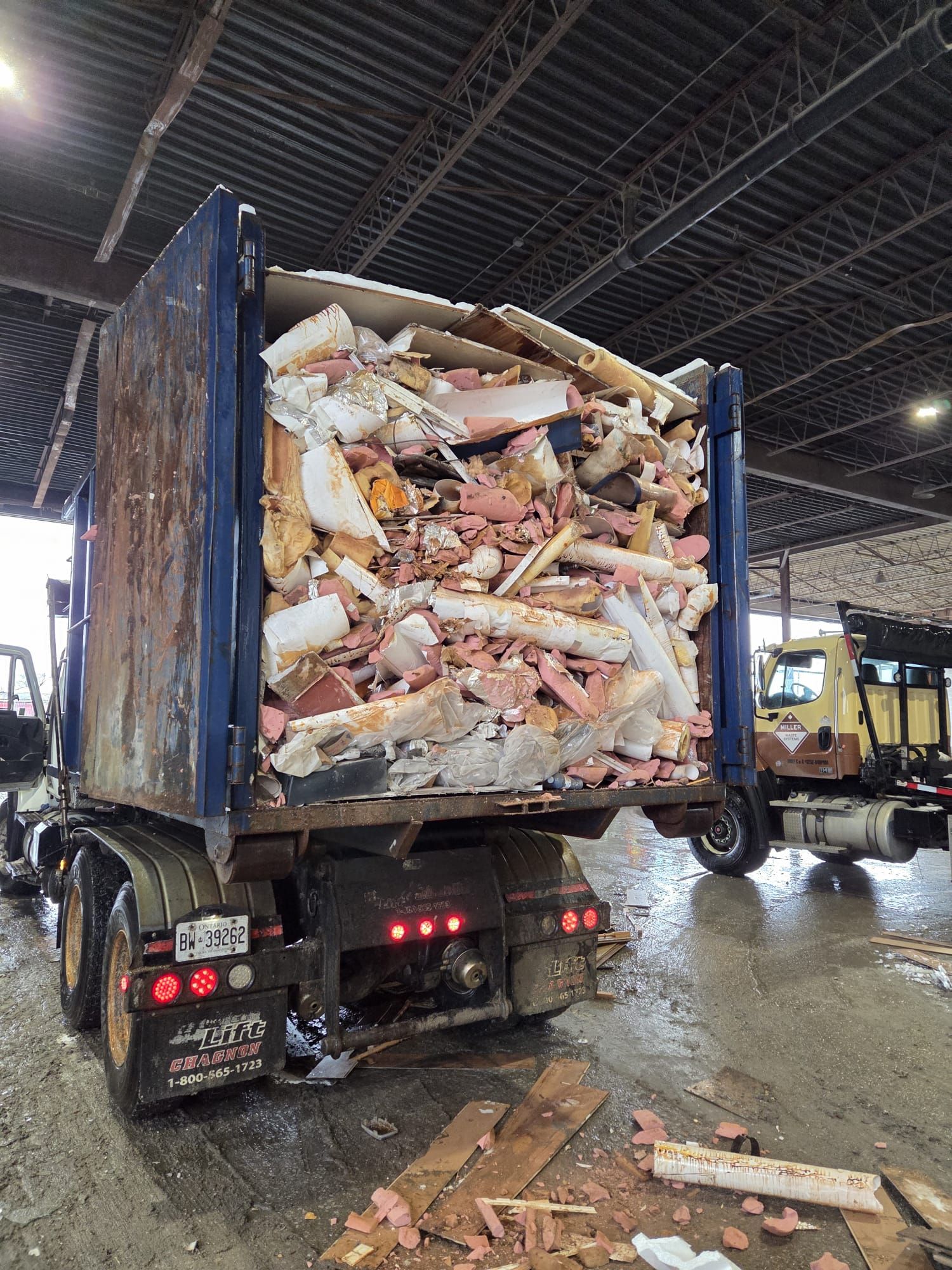 roll-off-dumpster-bin-construction-debris-truck-transfer-station