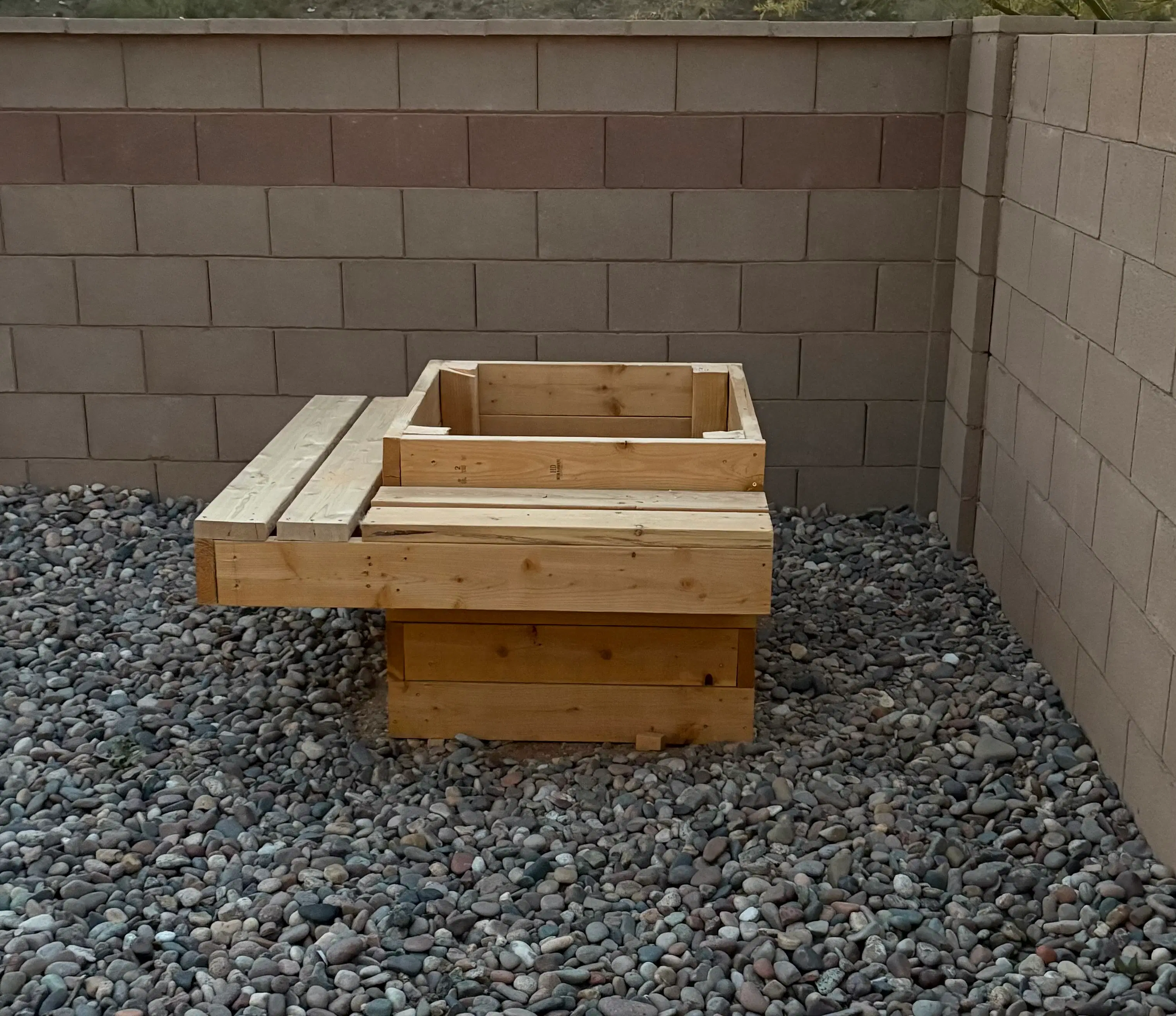 Custom-built wooden planter box with integrated bench seating