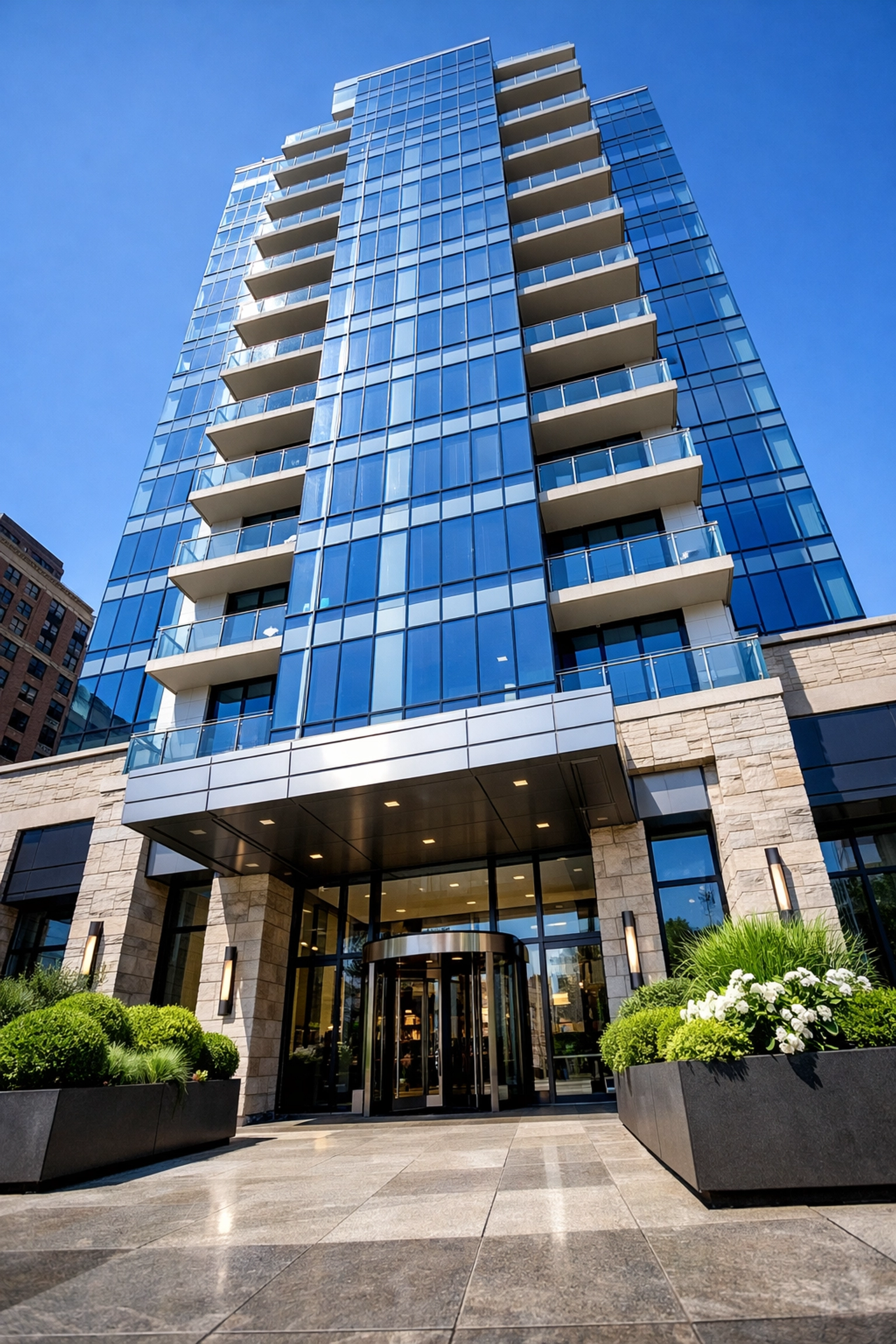 Pristine exterior and entryway of a luxury Midwest apartment building showing high-standard curb appeal.