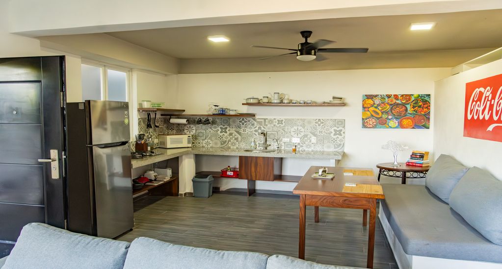 Modern open-plan studio apartment featuring a fully equipped kitchenette