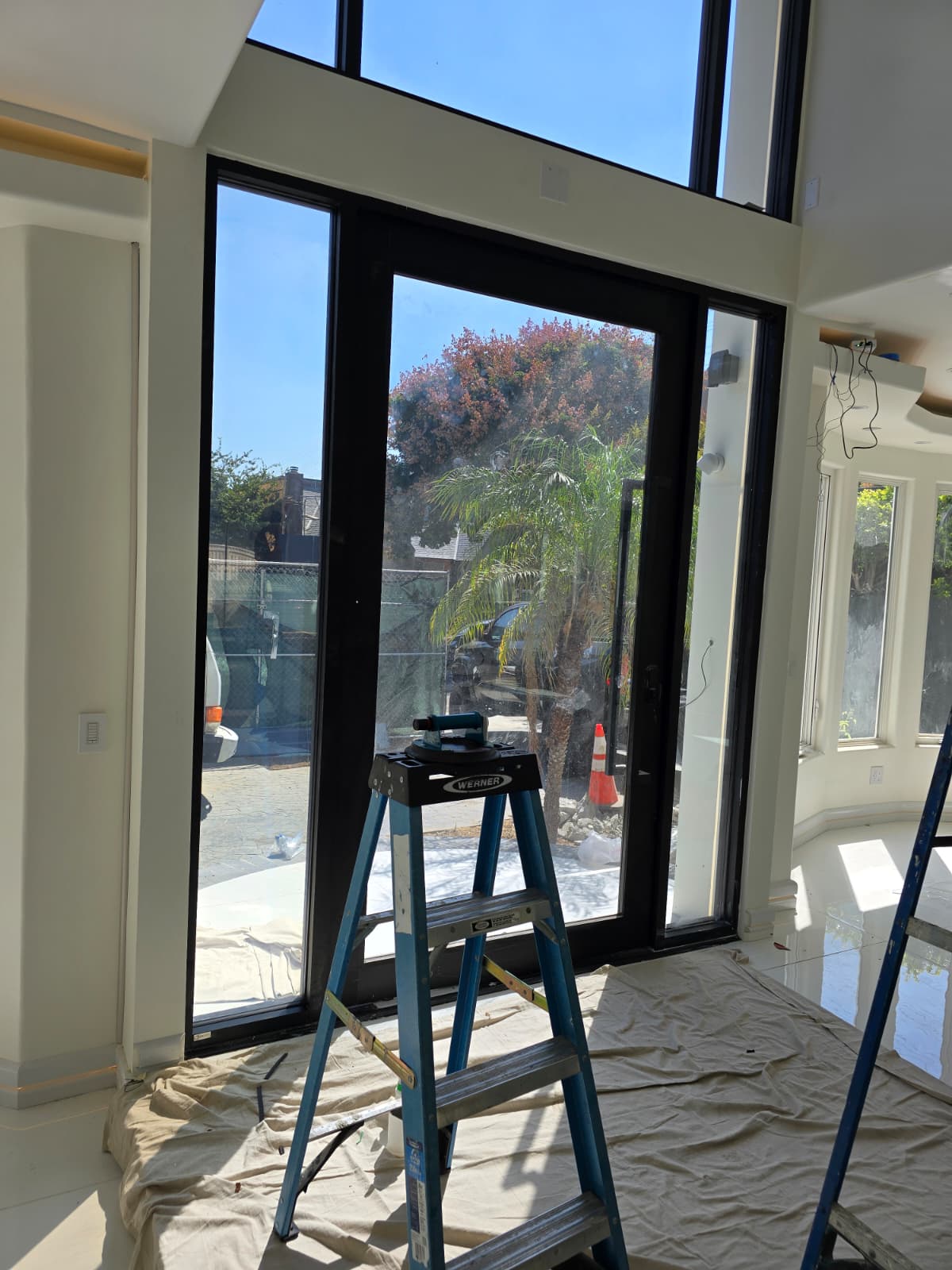 PDLC smart film installation preparation on large glass doors in a smart glass Lake Havasu project