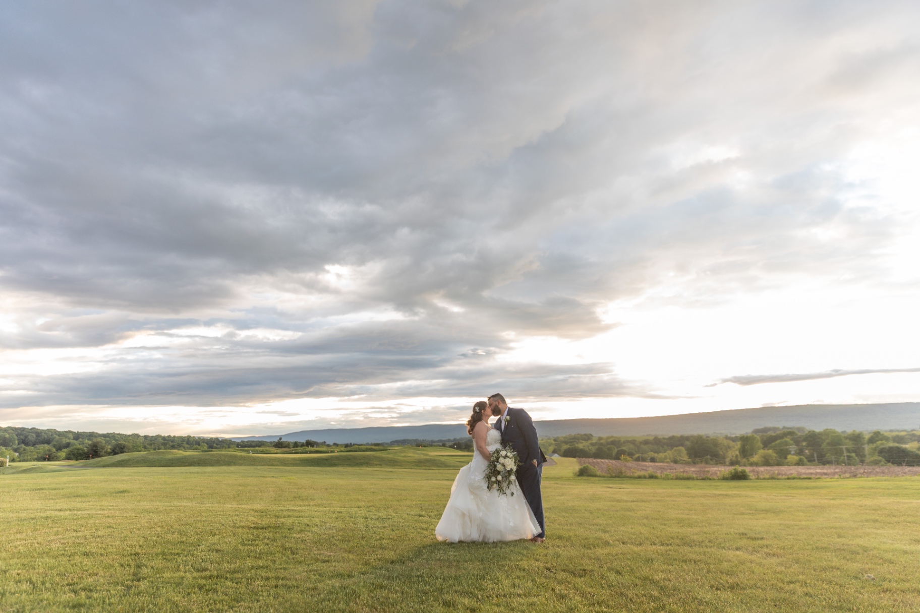 Natalie and Pat in an open field at sunset—cinematic, intimate, and timeless