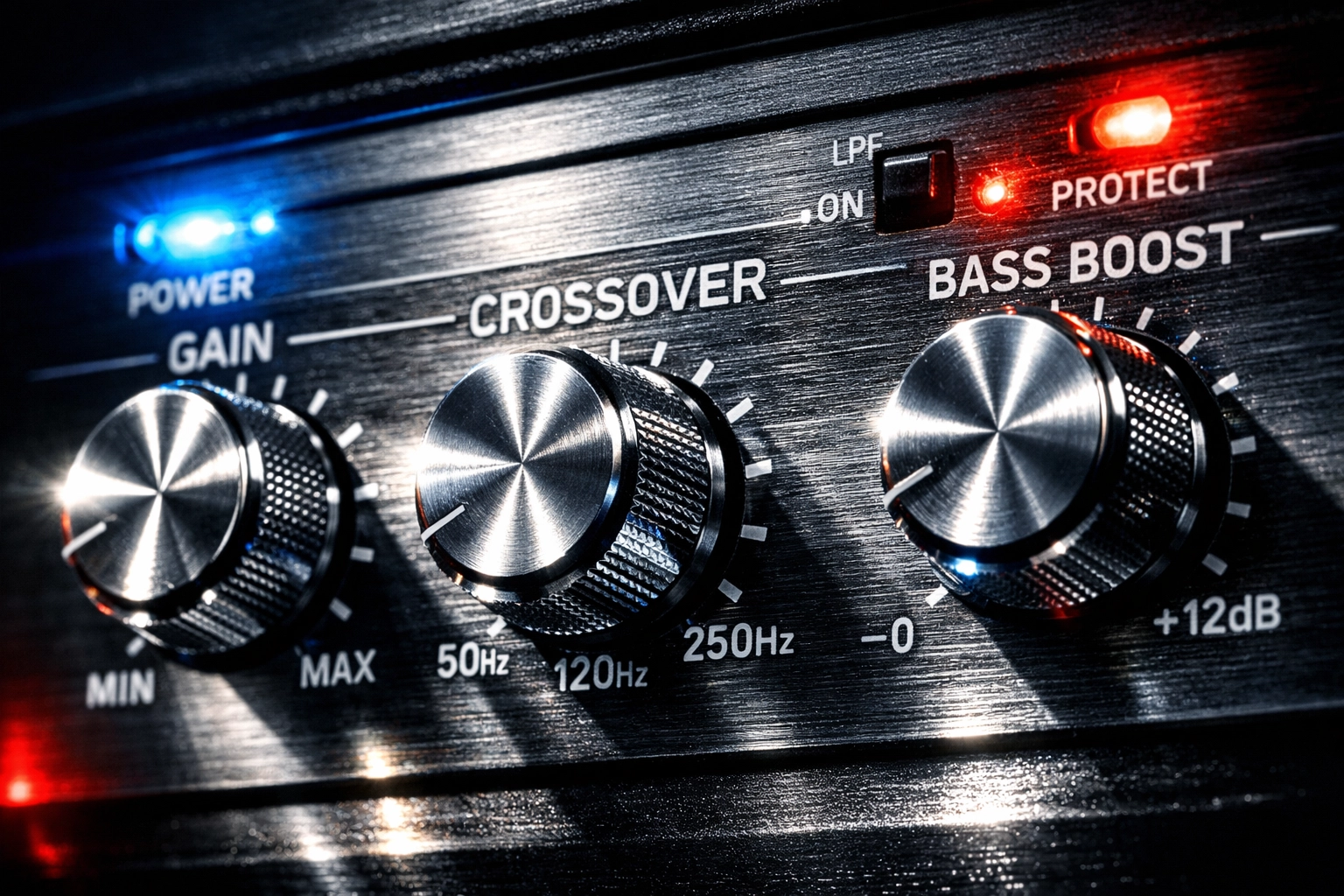 Car amplifier control panel showing gain, crossover, and bass boost adjustment knobs