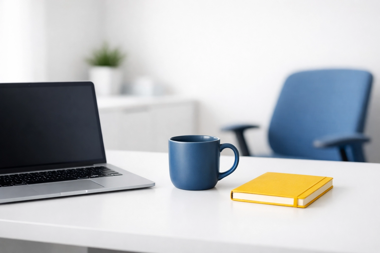 Organized minimalist office workstation with a white desk and blue accents promoting focus and productivity.