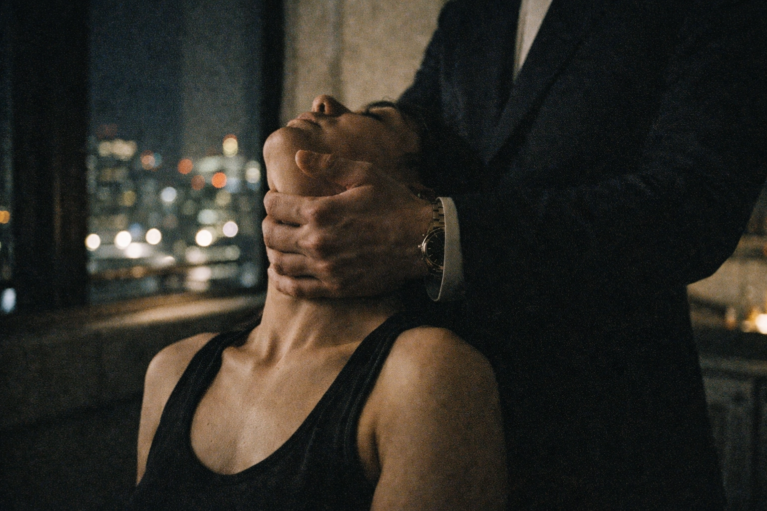 Dominant partner asserting control through touch demonstrating consensual power dynamic