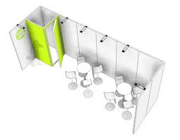 Crowded exhibition hall during build-up with anonymous workers on multiple stands