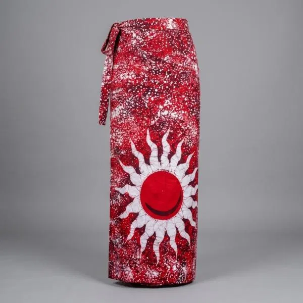 A vibrant red batik sarong with a white sunburst design