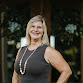 Real Estate Agent in Florida's Treasure Coast A professionally dressed woman stands confidently in front of a residential building, representing trusted real estate guidance and personalized client service for home buyers and sellers in Florida's Treasure Coast area.