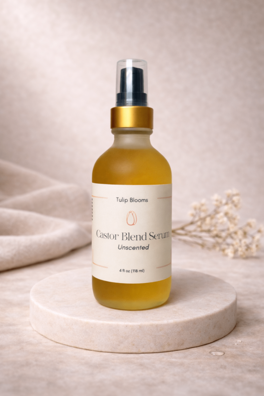 Tulip Blooms Castor Blend Serum on a neutral stone pedestal