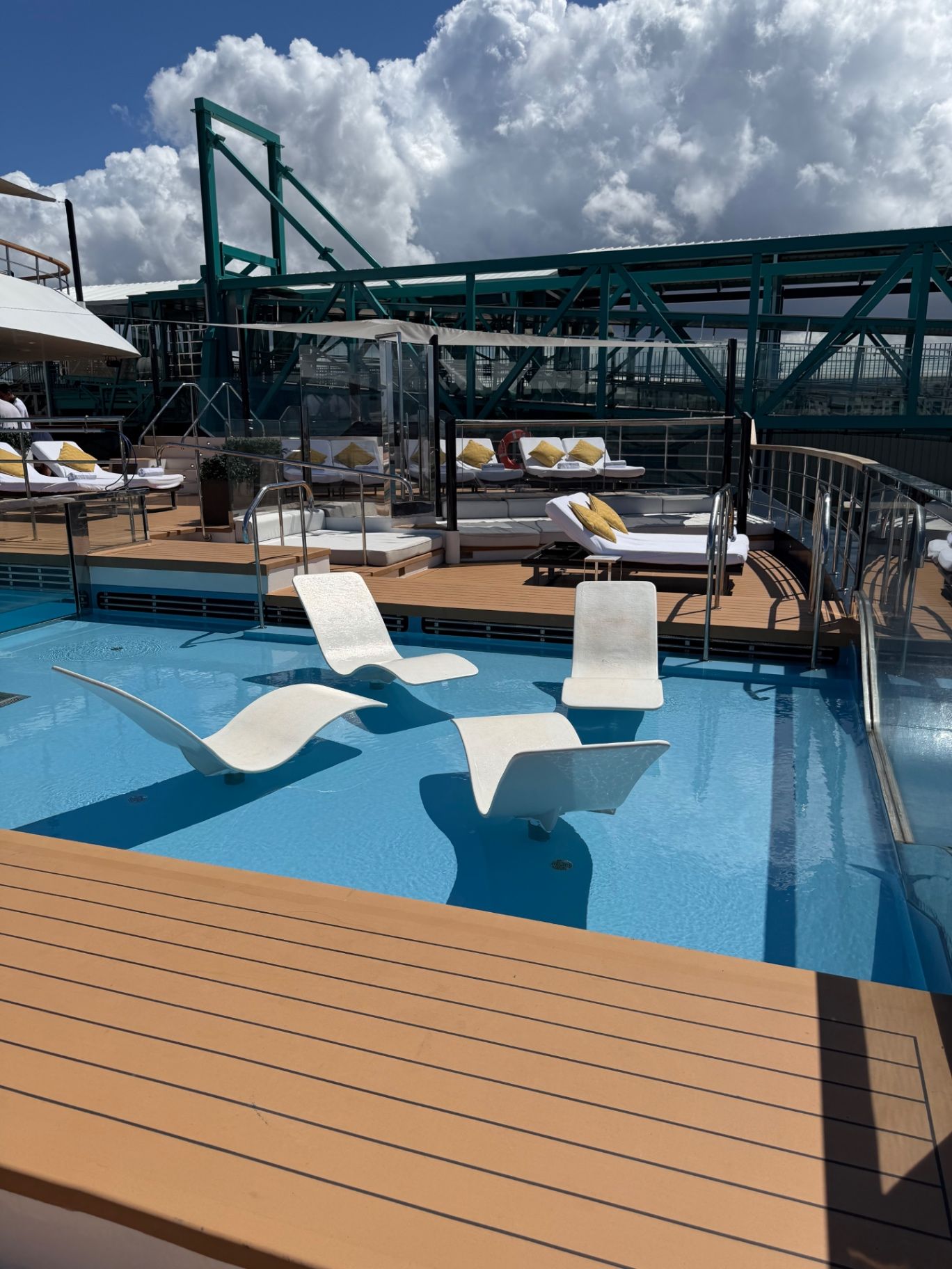 a pool with chairs and a deck