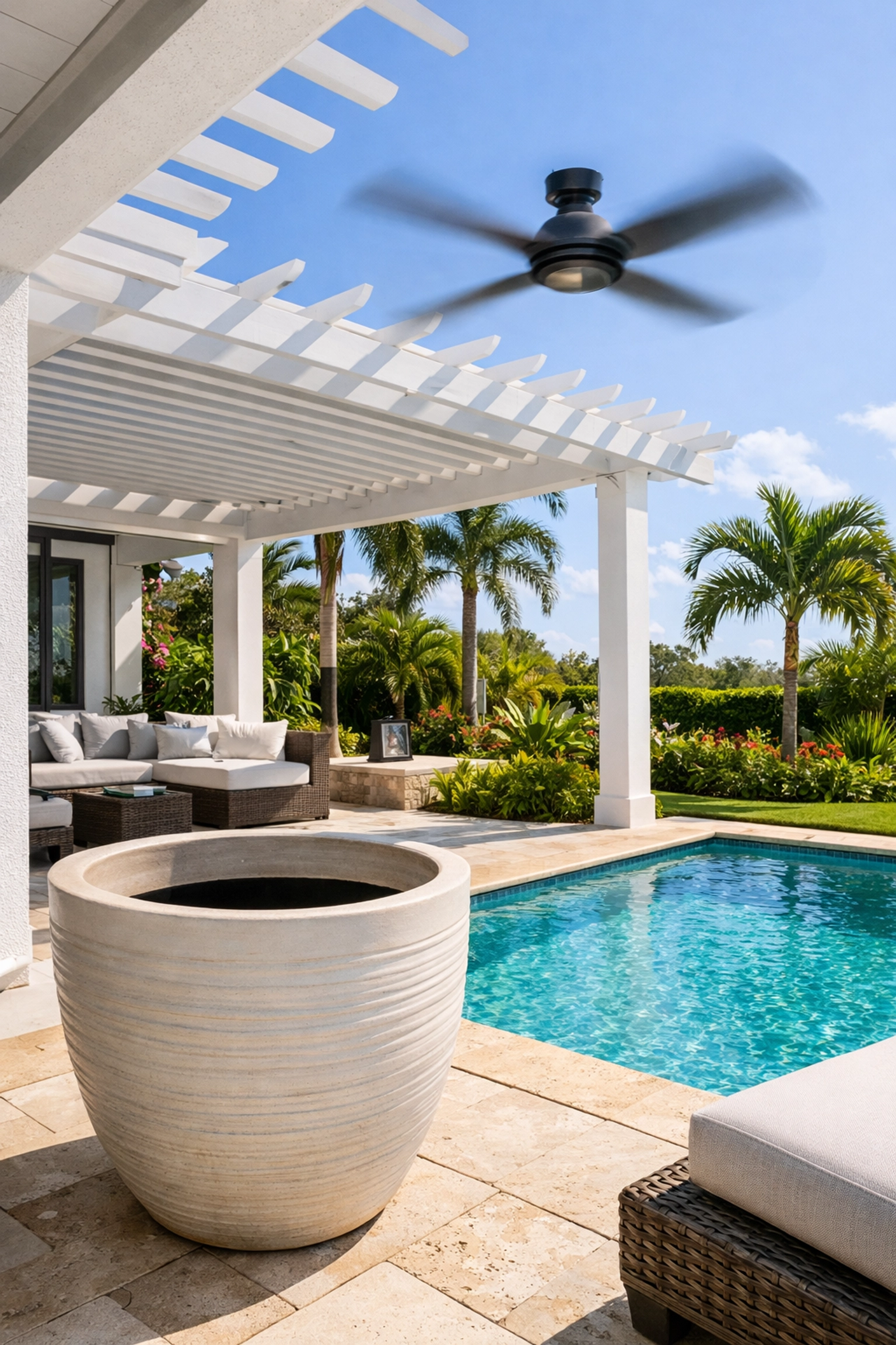 A pest-free Naples backyard patio with a pool and fan, illustrating effective mosquito control in Naples FL.