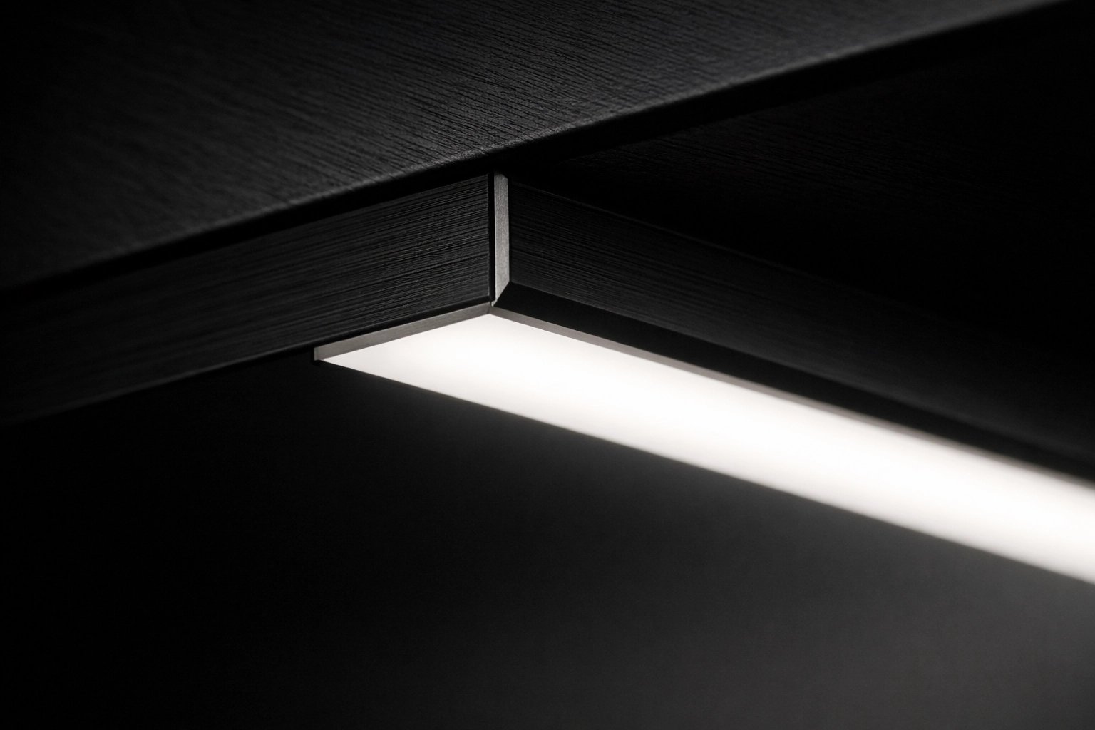 Modern black aluminum LED profile with a frosted diffuser for seamless, dot-less under cabinet lighting.