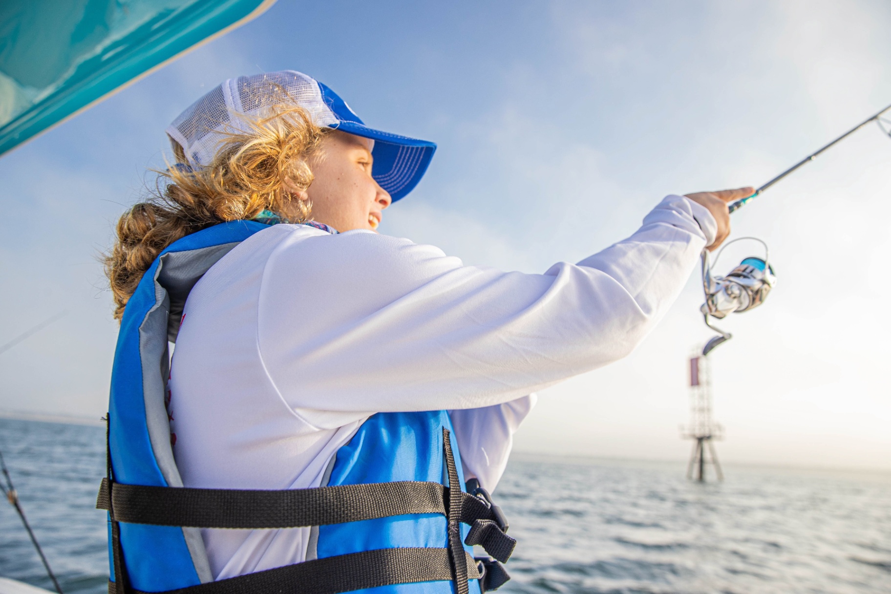 Young angler fishing from a boat