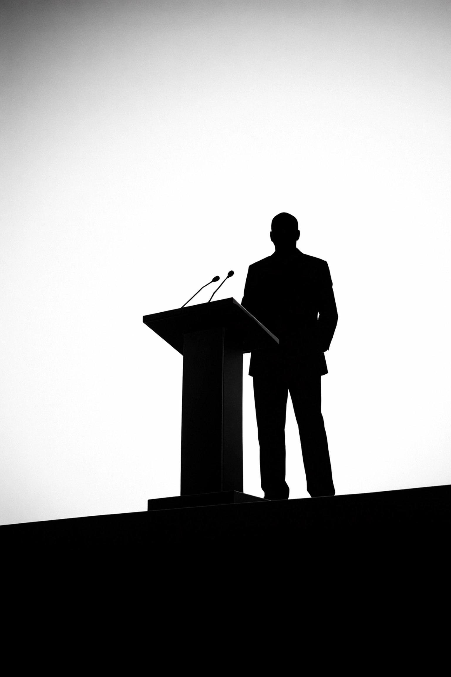 Low-angle silhouette of a keynote speaker at a professional Miami corporate event.