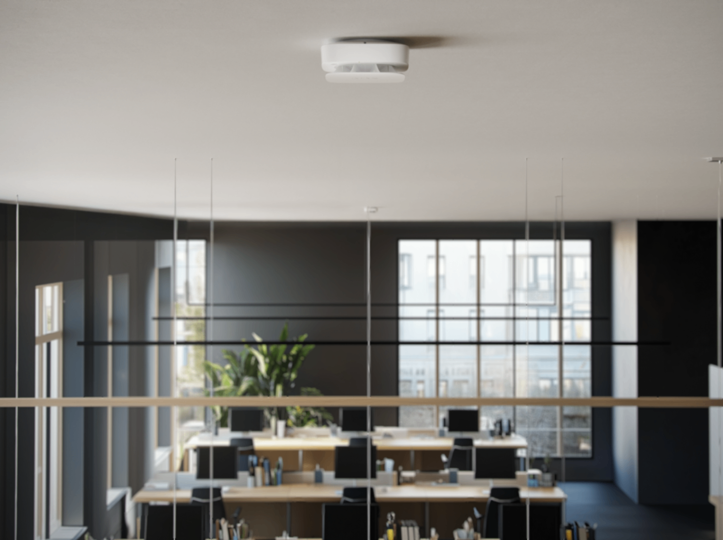 Modern open-plan office with a ceiling-mounted smoke detector