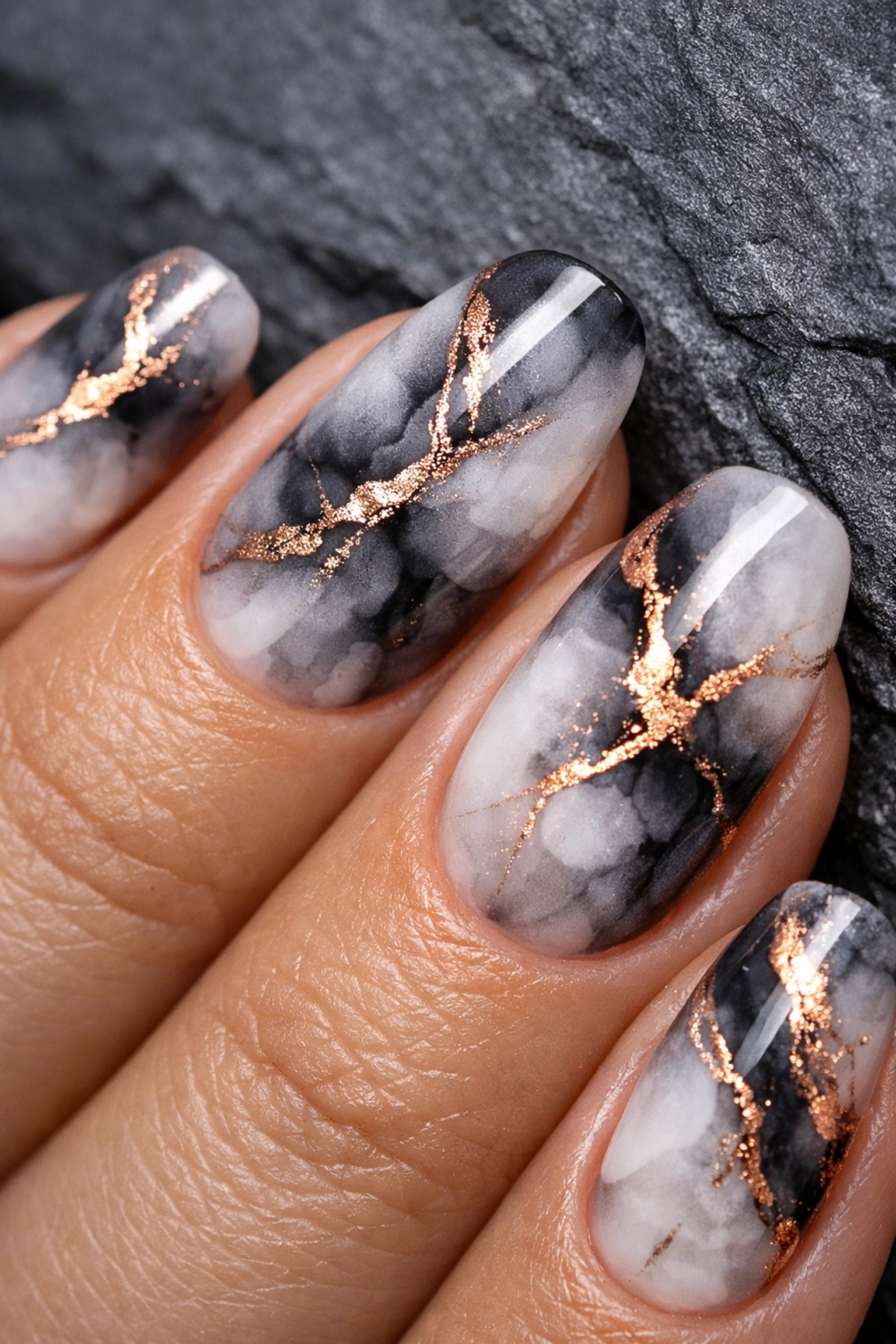 Detailed look at charcoal marble blooming gel nails with a clean Russian manicure finish at Jazzy Salons.