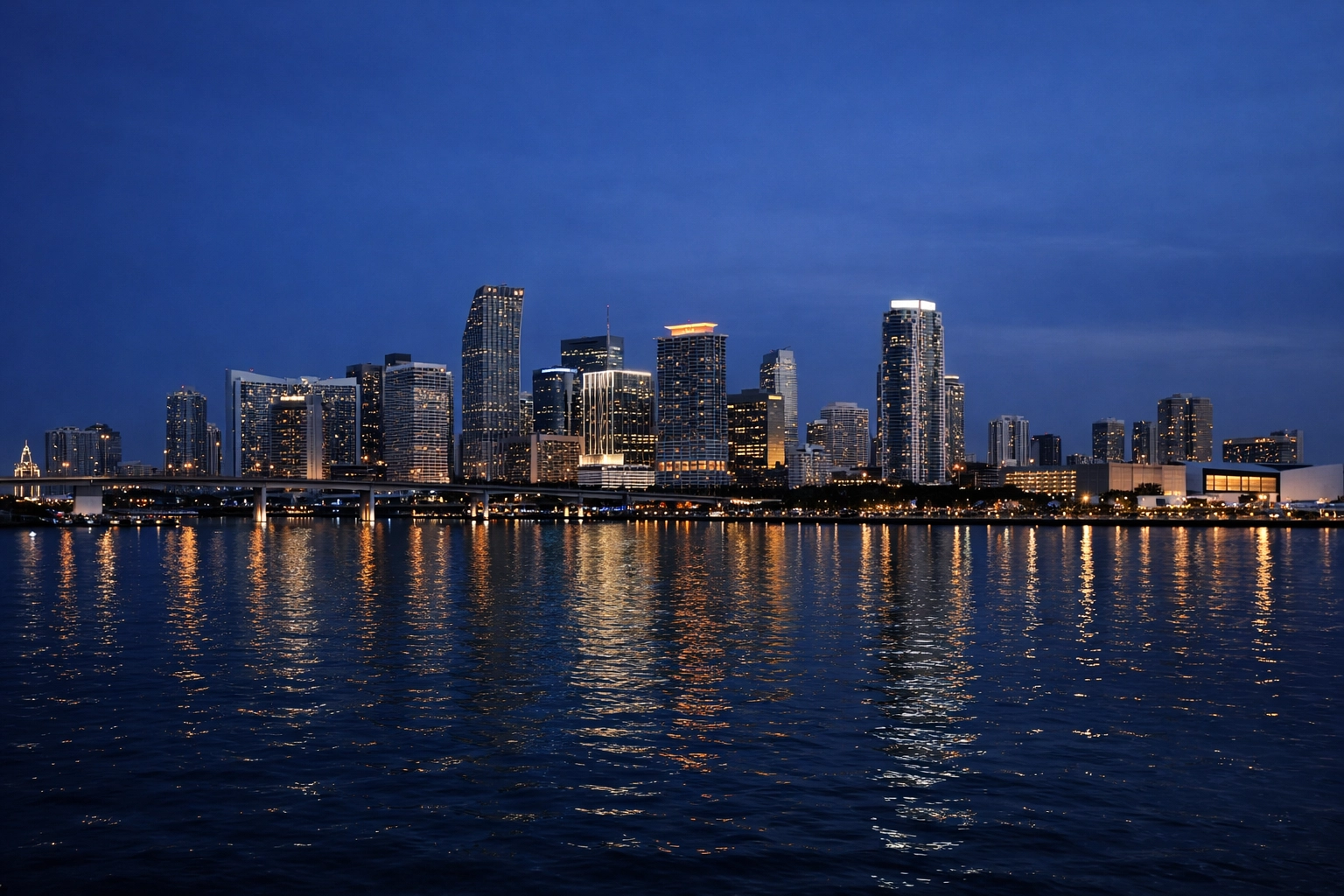 Stunning Miami skyline during blue hour with reflections on Biscayne Bay for long exposure photography.