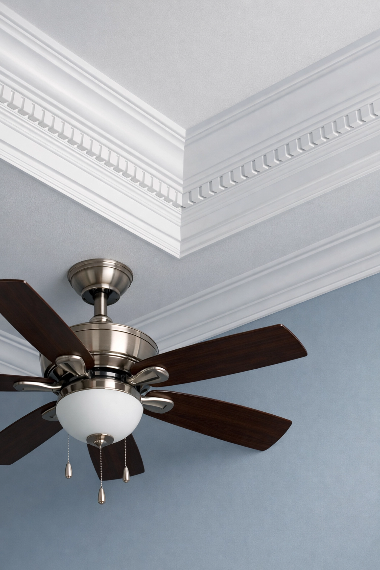 Detailed shot of clean crown molding and a dust-free ceiling fan after a professional deep cleaning.