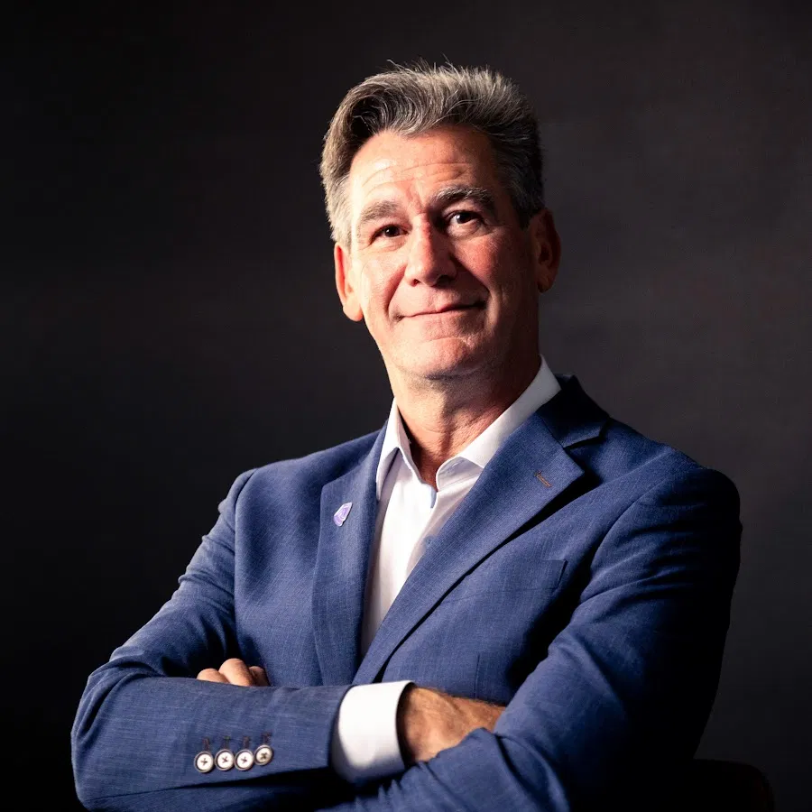 Mature executive in a blue suit reflecting trust and advisory credibility